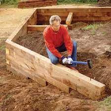 Concrete sleepers sydney lays out the steps on how to build a retaining wall on a slope. How To Build Wood Retaining Wall Garden Retaining Wall Wood Retaining Wall Landscaping Retaining Walls