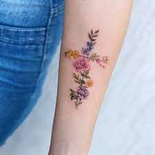 This is nice, but i would like the dogwoods with an open book, saying escape, and lily of the valley on it too. 50 Beautiful Cross Tattoos To Showcase Your Faith Inspirationfeed