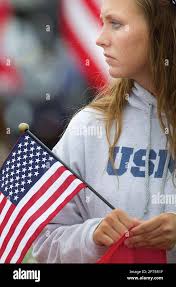 Charity Crawford, 20, of Rimersburg, Pa. stands at the edge of the road  near the Oakland Church of God in Distant, Pa. Thursday, June 16, 2011, to  pay respects to Marine Sgt.