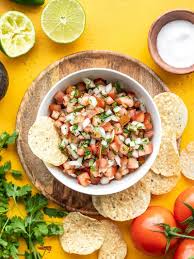 Add one avocado, ¼ cup sour cream, ¼ cup mayonnaise, 1 clove of garlic, ¼ cup cilantro, 2 tbsp lime juice, and ¼ tsp salt to a blender or food processor. Pico De Gallo
