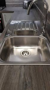 We are so happy with the quality of the units and the service you provided.' Kompact Slab Light Grey Gloss Kitchen Wood Effect Laminate Appliances