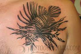 There is something about the graceful movement of fish in water that makes it a very attractive design. Really Cool Tribal Lionfish Tattoo Ink Tattoo Tatoo Styles Lion Fish