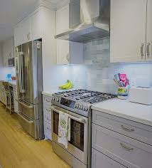 New clear glass panels and a fresh coat of paint on the upper cabinets refreshed the room's style at minimal cost. A Galley Kitchen With Modern Style Kitchen Mart