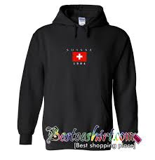 Soft hoodie in black with suisse 1984 swiss flag embroidery on the chest, drawstrings, and kangaroo pockets. Suisse Flag 1984 Hoodie