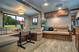 The living area has an entertainment center with led tv and fireplace, a dinette, and a theatre setting. Top 5 Best Travel Trailers For Large Families Rvingplanet Com