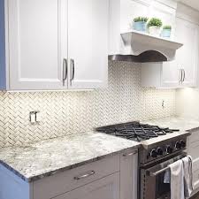 Pastel Blue And White Cabinets With Silver Metal Handles Inside A Kitchen With Off Whi In 2020 Kitchen Backsplash Designs Small White Kitchens Kitchen Tiles Backsplash