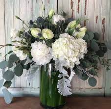 Send White Hydrangea White Roses Blue Erigum White Amarialys Dusty Miller And Silver Dollar Eucalyptus In Hermos White Roses Florist Design White Hydrangea