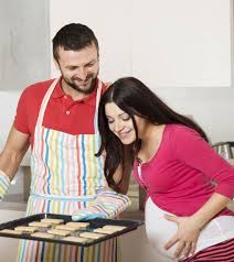 Studio shooting husband kissing pregnant wife lying on the floor. Wife And Husband Relationship During Pregnancy This Is What You Need To Know