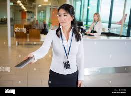 Female Staff Giving Passport At Airport ...