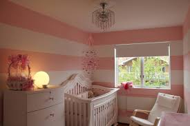 The bed and pillow covers are in dotted black and pink ruffles. Girly Pink Stripes Project Nursery