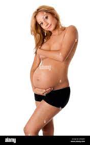 Beautiful new happy naked mother in late pregnancy wearing black panties,  holding belly and covering breasts, isolated Stock Photo - Alamy