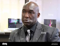 In this May 7, 2019 photo, former inmate Daryl McGraw, of New London,  speaks at the New Britain, Conn., offices of the Children with Incarcerated  Parents Initiative, about the financial hardship of