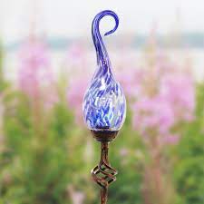 These are so beautiful in the evening. Solar Hand Blown Pearlized Blue Glass Spiral Flame Garden Stake With Metal Finial Detail 36 Inch Exhart Home Garden Decor