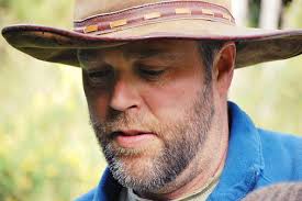 Man In Cowboy Hat In Rural Scene In Winter Stock Photo