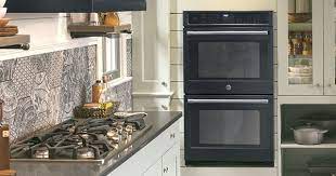 The colorful glass tiles complement the dark wood cabinetry and gives this kitchen an overall urban edge. 4 Color Palettes That Pair Perfectly With Black Kitchen Appliances Purewow