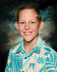 What does this image of the young man with dark curly hair and a boyish  grin remind you of?