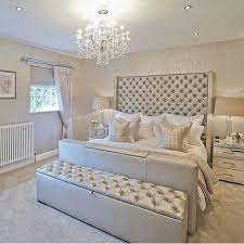 Gray and silver bedroom features a silver metallic foil wallpaper lined with a gray wingback bed dressed in white and gray bedding flanked by mirrored nightstands placed under mirrors. Modern Silver Bedroom Decor Novocom Top
