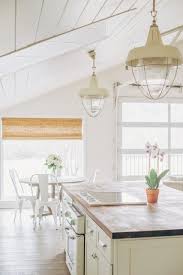 A white and dove gray kitchen is up with the trends showcasing white floating shelves mounted on a white and gray quartz backsplash slab over dove gray kitchen drawers with brass pulls. My Favorite Interior Paint Colors Sarah Catherine Design