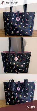 A floral tote bag by kate spade, presented in black with a red, pink and white rosette motif, a zip closure and a patterned fabric lining. Kate Spade Kaci Wildflower Small Tote Bag Navy Kate Spade Kaci Small Tote Brand New With Tags Smooth Leather Small Tote Bag Small Tote Kate Spade Tote Bag