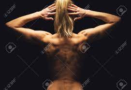 Full body length portrait isolated over gray studio background. Woman Flexing Her Muscles And Showing Her Toned Back Stock Photo Picture And Royalty Free Image Image 19810085