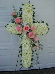 A funeral cross is a beautiful way of representing loved ones. Standing Cross For Funeral Tribute White Cushion Pomps With Pink Rose Sash Funeral Flower Arrangements Funeral Flowers Funeral Arrangements