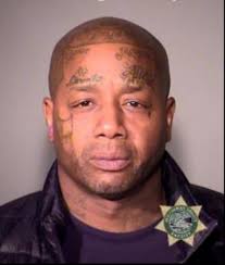 Tattooed defendant in altered ID photo case back in court due to new theft  allegation