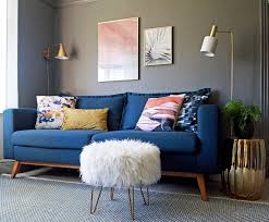 The rich raspberry shade invigorates this traditional living room with sassy energy. Living Room Design Blue Sofa Grey Walls And Accents In Pink White And Gold First Sense In Blue Living Room Decor Blue Sofa Living Blue Sofas Living Room