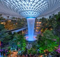 The buzzing southeast asian hub serves 62 million travelers each year and makes layovers more fun by loading up each terminal with amenities. The Rain Vortex Waterfall Located Inside The Jewel Changi Airport In Singapore Travel Off Path