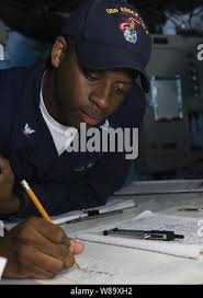 Petty Officer 3rd Class Jonathan Holman (right), a marine science  technician with the Coast Guard Marine Safety Task Force (MSTF), speaks  with Teller Native Corporation employees during a facility inspection in  Teller,