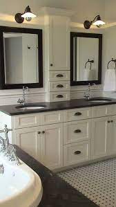 Gleaming dark countertops will make finely crafted molding around the cabinets more obvious. 24 Gorgeous Light Cabinets Dark Countertops Bathrooms Remodel Bathroom Remodel Master Small Bathroom Remodel