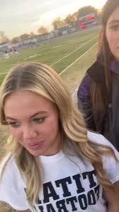 Katie Sneezing in Front of A Football Team