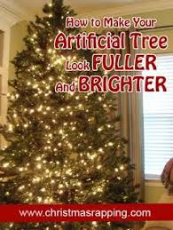 How To Make Your Artificial Tree Look Fuller And Brighter With Extra Garland Xmas Tree Lights Artifical Christmas Tree How To Make Christmas Tree