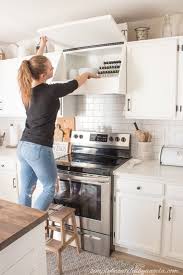 We painted the range hood cover the same color as our trim, rather than the walls. Diy Range Hood Cover With Storage Simply Beautiful By Angela