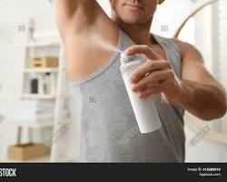person applying deodorant