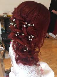 Think buns, twisted updos, and ponytails. Red Hair Curled One Side Hair Style With Gypsophila Red Wedding Hair Red Hair Brides Boho Wedding Hair