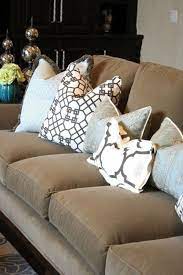 This brown sofa is totally spiced up with some colourful geometric pillows with tons of various coloration accents. Hugedomains Com Living Room Pillows Teal Sofa Living Room Home Decor