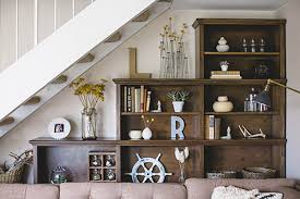 The drawer compartments make a great spot to store shoes out of sight. Home Living Room Design Under Stairs