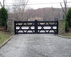 A grand wooden gate introduces the series of arrival sequences to be taken in along the private drive to the main ranch grounds. Here S A Great Modern Farmhouse Style For You We Added Welded Wire Mesh To The Open Design Because Th Farm Gate Entrance Fence Gate Design Farm Gates Entrance