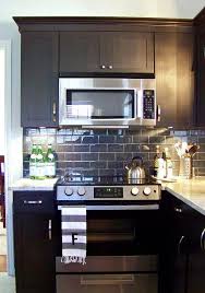 Black Cabinets Granite Countertops And A Pretty Subway Tile Backsplash Updated Kitchen Home Home Kitchens