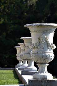 One of the features of classic gardens is the careful placement of attractive seating from which to raised on a plinth, this classic urn planted with striking red amaryllis in marle place garden in the uk. Garden Urn Flickr Search Garden Urns Traditional Garden Classic Garden