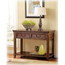 This cocktail table is quite versatile in that it features a simple pop up lift top which will serve as your work surface, storage bottom and side drawers and also part of the house décor. T478 20 Ashley Furniture Lift Top Cocktail Table