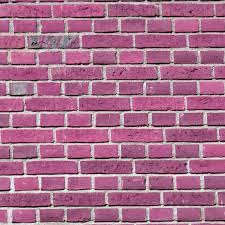 Free Colored Brick Wall Backgrounds Arte Handheld clip of brick building with people walking in foreground.