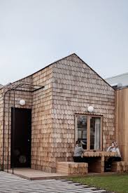The calming sound of the water and a breeze coming through the windows make lake vacations a special sort of getaway. This New House Covered With Shingles Adds Some Woodly Charm To The Street