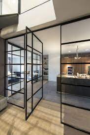 Get a wooden bed for the room to create a complete match. Black Framed Glass Doors Are A Prominent Feature Of This Apartment S Interior Design