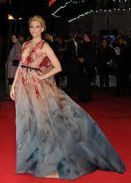 Lady gaga is wearing a tutu, gold accessories and large gold mockingjay brooch,' said another, comparing gaga to both katniss and elizabeth banks' character, effie trinket. Elizabeth Banks At Premiere Of The Hunger Games Mockingjay Part 1 In London Gotceleb