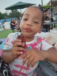 Baby eating crawfish at the park