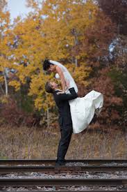 Whether it’s to soundtrack the ceremony, the reception, or the first dance of the evening, let’s raise a glass. Wedding Groom Lifting Bride Fall Colors Train Tracks Long Lake Regional Park New Brighton Mn Before Michael Anderson Photography