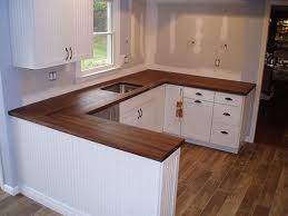 Floor cabinets have recessed bases and countertops contemporary setting for a white and green kitchen surrounded by cabinets made out of solid wood with a white coat of paint and dark handles. Pin On Dark Wood Countertop Eating Bar Ideas