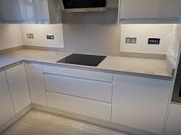 White kitchen with grey worktops. Remo White Gloss Kitchen With Grey Shimmer 20mm Quartz Worktops Up Stands And Splashback