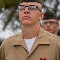 U.S. Marine Sgt. David Busenbark, center, a small arms